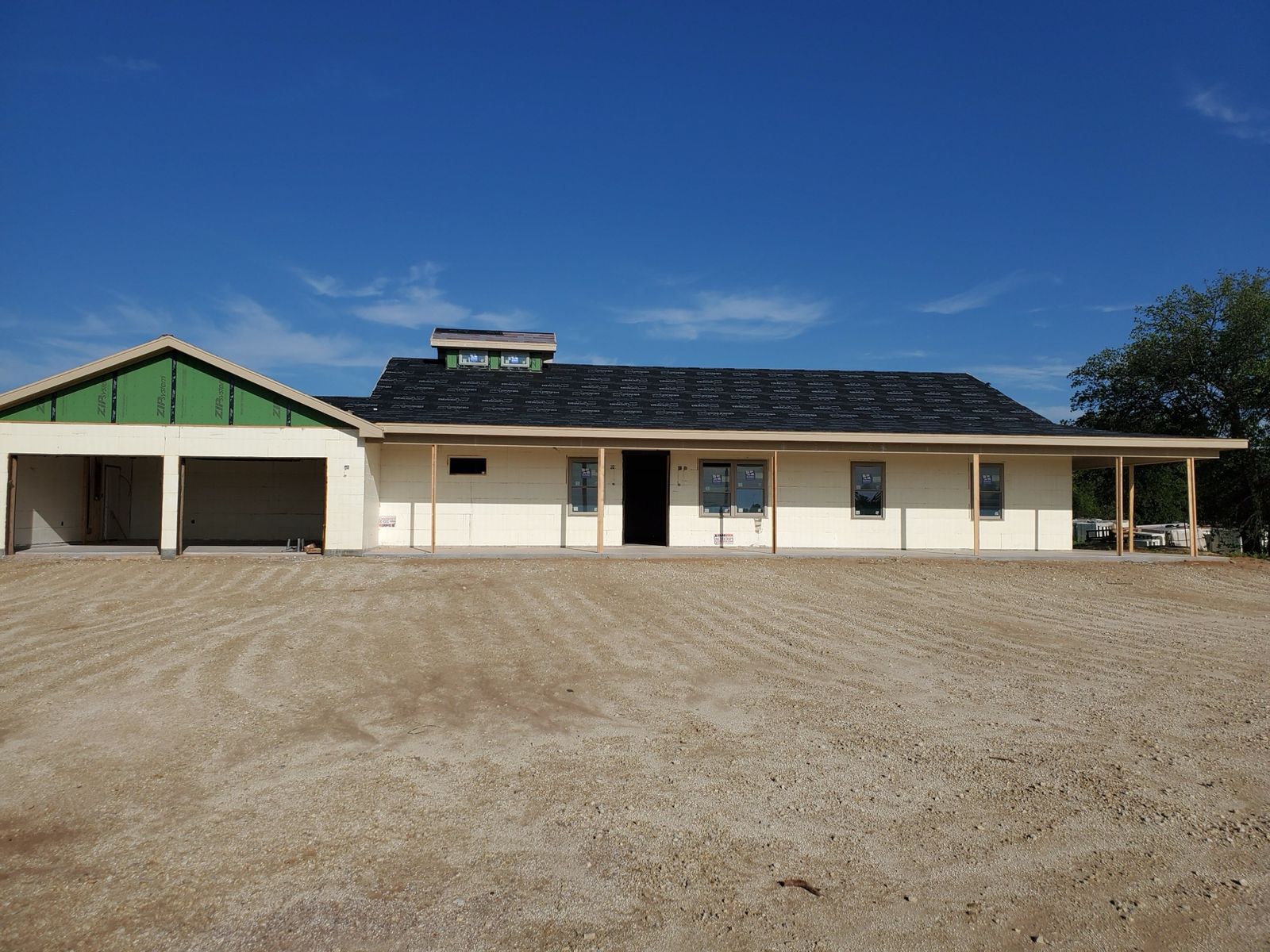 Completed custom home exterior with brick and covered entry built by Visten Construction Group